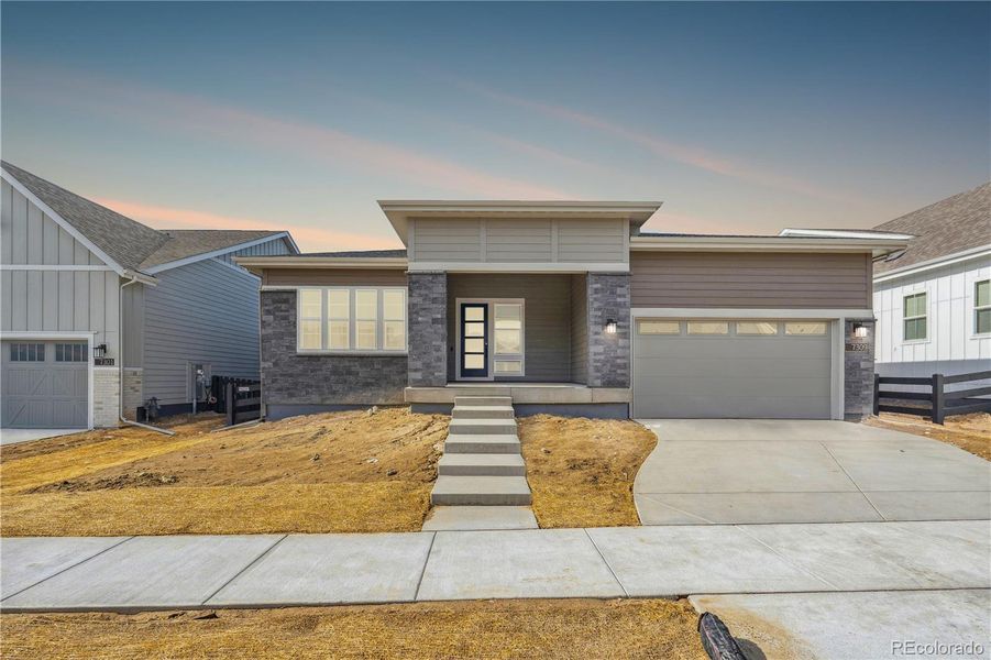 Front exterior of a new home in Retreat at The Canyons, Castle Pines, CO, highlighting curb appeal (Image 2). Front exterior of a new home in Retreat at The Canyons, Castle Pines, CO, highlighting curb appeal (Image 2).