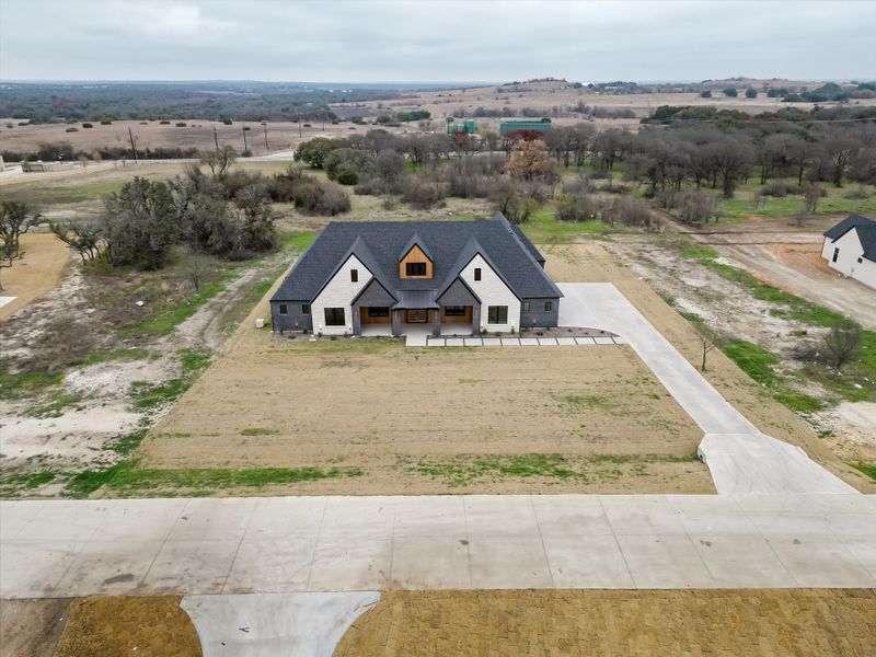 Front exterior of a new home in Summit Ranch, Aledo, TX, highlighting curb appeal (Image 31). Front exterior of a new home in Summit Ranch, Aledo, TX, highlighting curb appeal (Image 31).