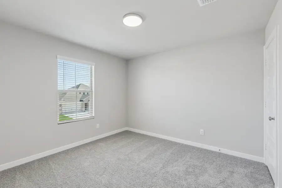 Bedroom in the Holden home plan by Trophy Signature Homes – REPRESENTATIVE PHOTO
