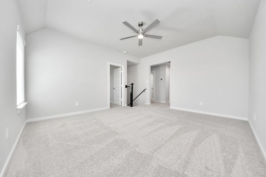 Discover a haven of leisure in this fantastic game room! Whether you're seeking a casual hangout or an adult gaming retreat, this space has it all. Enjoy the luxurious feel of plush carpet underfoot, the expansive ambiance of high ceilings, custom paint that adds a touch of personality, and windows that flood the room with refreshing natural light. Sample photo of completed home with similar floor plan. Actual colors and selections may vary.