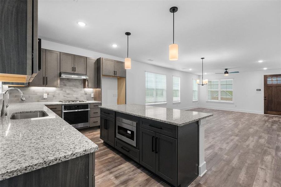 Kitchen with granite countertops and stainless steel appliances Kitchen with granite countertops and stainless steel appliances