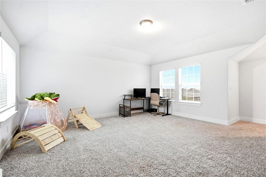 A versatile bonus room offers ample space perfect for recreation or a home office.