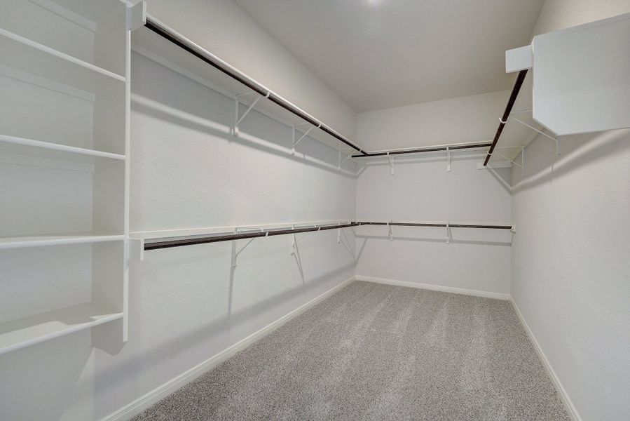 Primary suite walk-in closet in the Pearl floorplan at a Meritage Homes community.