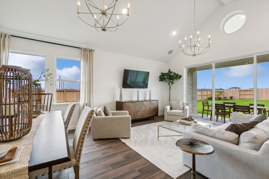 Great room with vaulted condition and chandelier