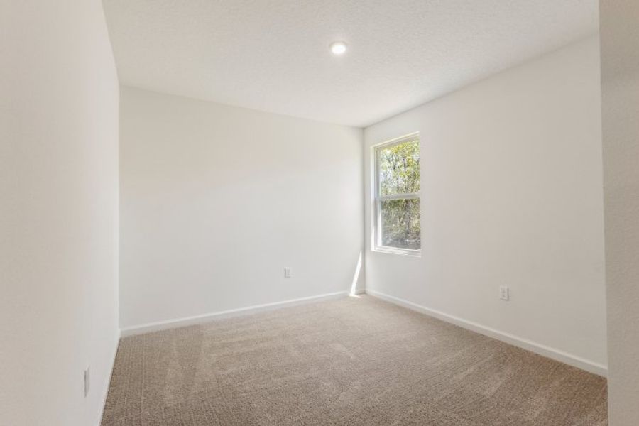 A room with a carpet and a window. A room with a carpet and a window.