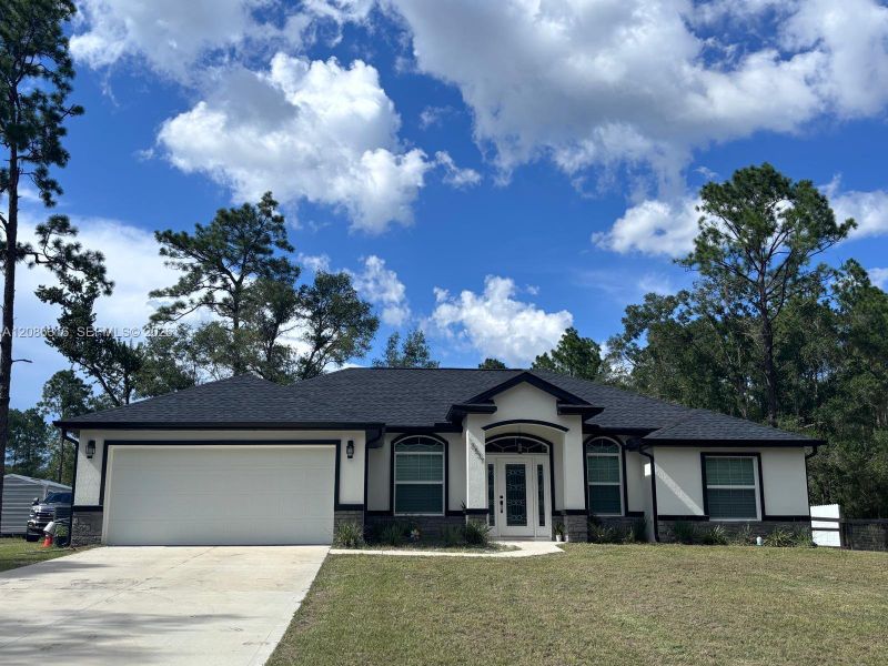 Front exterior of a new home in , Dunnellon, FL, highlighting curb appeal (Image 15).
