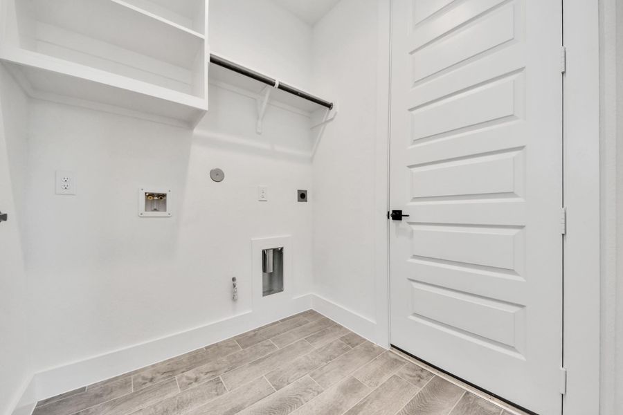 A perfect blend of functionality and comfort. Capture the essence of easy living with a first-floor laundry room, thoughtfully equipped with shelving for effortless organization. Both electric and gas connections available. Sample photo of completed home with similar floor plan. Actual colors and selections may vary. A perfect blend of functionality and comfort. Capture the essence of easy living with a first-floor laundry room, thoughtfully equipped with shelving for effortless organization. Both electric and gas connections available. Sample photo of completed home with similar floor plan. Actual colors and selections may vary.