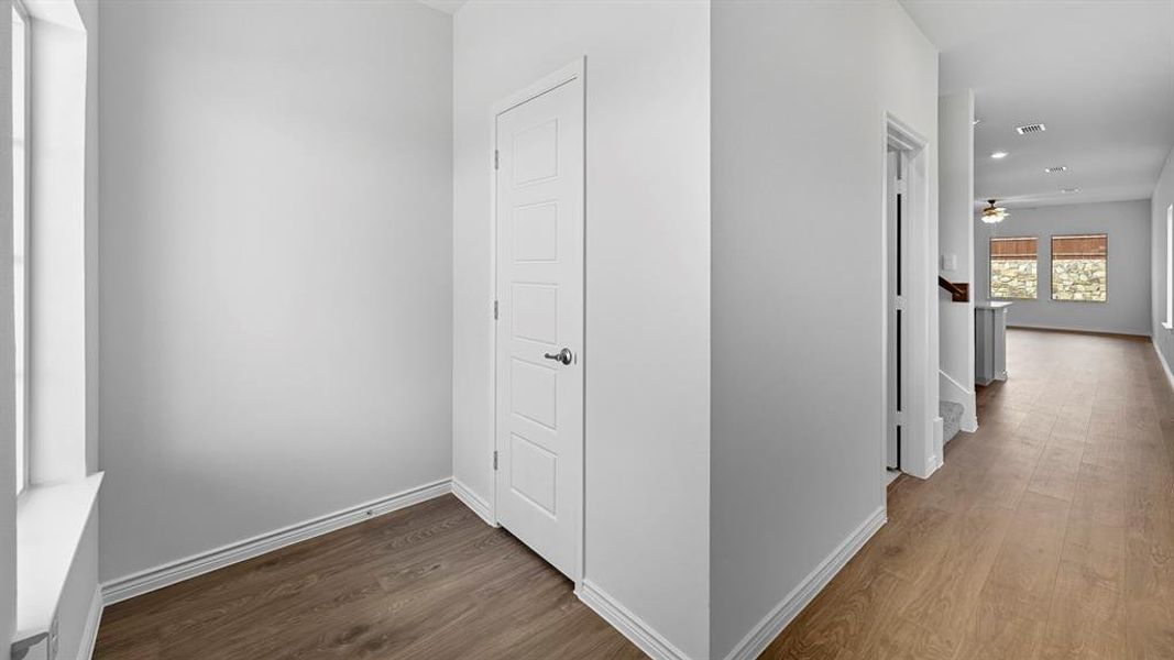 Hall featuring dark wood-style floors and baseboards