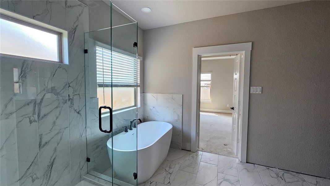 Bathroom featuring plus walk in shower and tile patterned floors