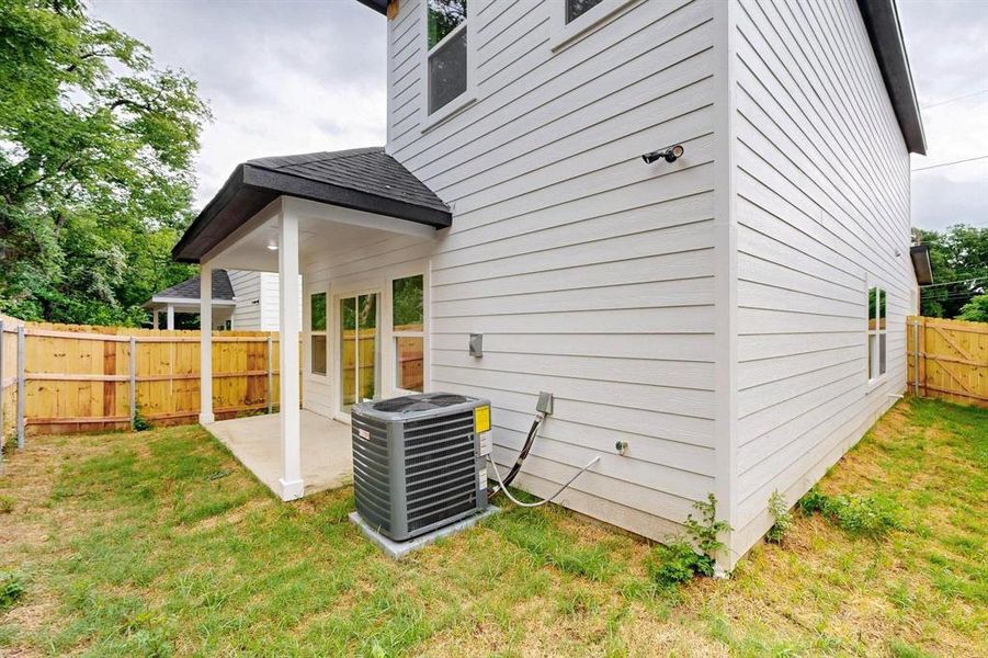 Back of house with a patio, a fenced backyard, and a shingled roof Back of house with a patio, a fenced backyard, and a shingled roof
