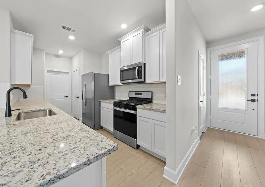 The kitchen of the Cedar has beautiful white wood cabinets. The kitchen of the Cedar has beautiful white wood cabinets.
