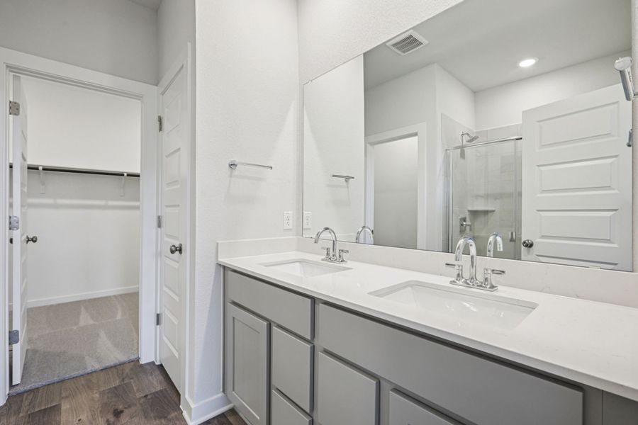 A bathroom with a large mirror.