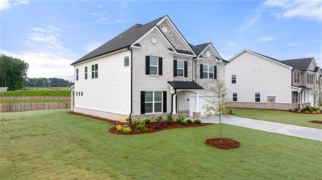 Front exterior of a new home in Independence, Loganville, GA, highlighting curb appeal (Image 17).