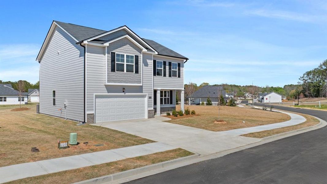Front exterior of a new home in Champion's Run, Lithonia, GA, highlighting curb appeal (Image 24).