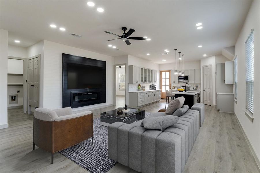 Living area with recessed lighting, light wood-style floors, ceiling fan, and a glass covered fireplace Living area with recessed lighting, light wood-style floors, ceiling fan, and a glass covered fireplace