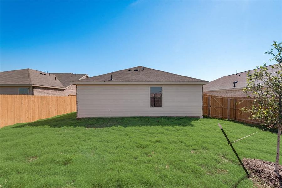 Rear view of house featuring a yard