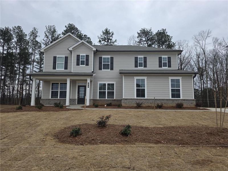 Front exterior of a new home in Oakhurst Manor, McDonough, GA, highlighting curb appeal (Image 2). Front exterior of a new home in Oakhurst Manor, McDonough, GA, highlighting curb appeal (Image 2).