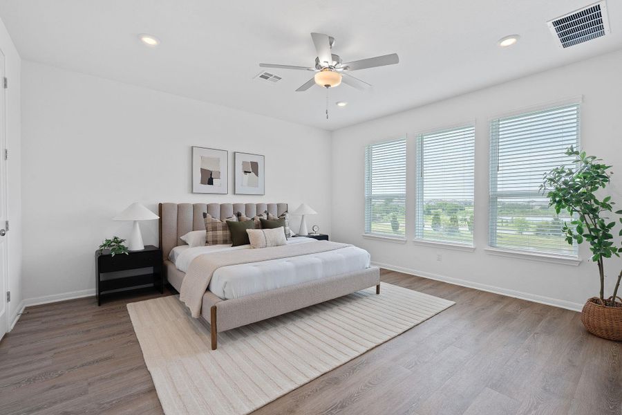 Bedroom featuring wood finished floors, baseboards, recessed lighting, and a ceiling fan