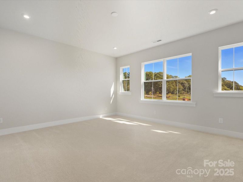 Primary Suite With Unobstructed Views Through Large Windows.