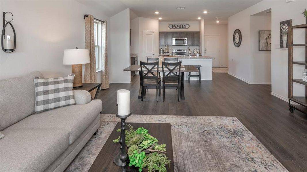 Living room featuring recessed lighting and dark wood-type flooring