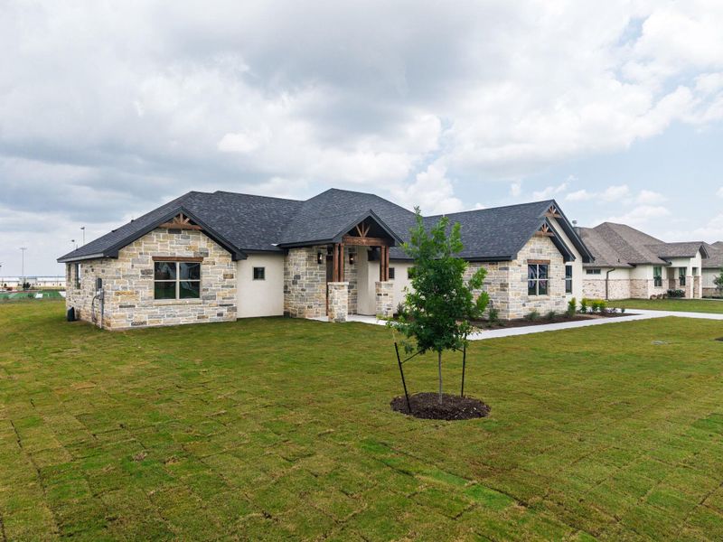 A well-maintained lawn and stone facade enhance this single-story residence. A well-maintained lawn and stone facade enhance this single-story residence.