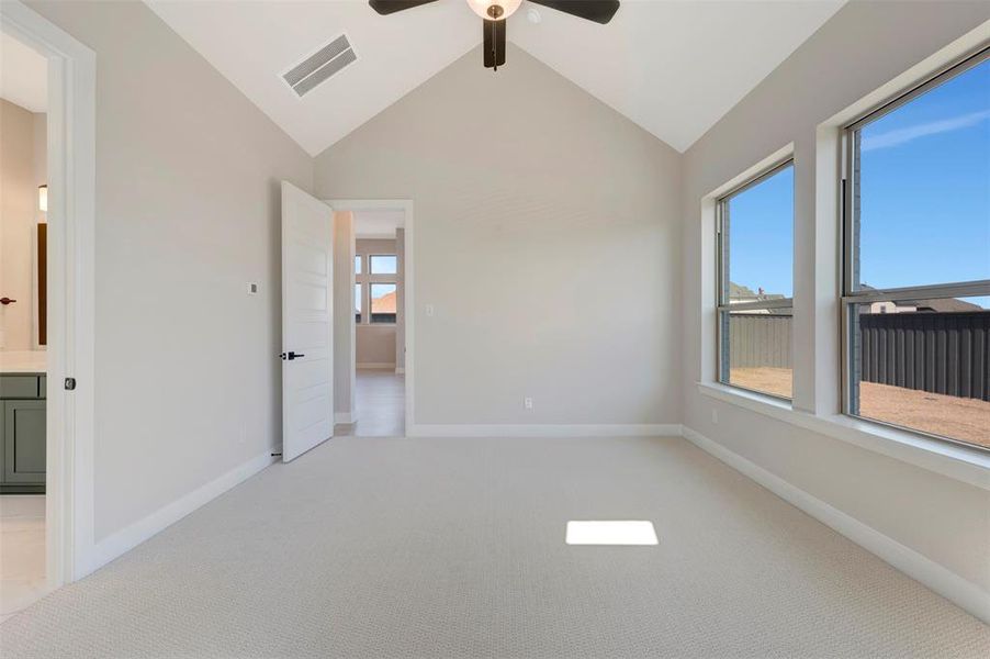 Unfurnished bedroom with light carpet, a ceiling fan, and connected bathroom Unfurnished bedroom with light carpet, a ceiling fan, and connected bathroom