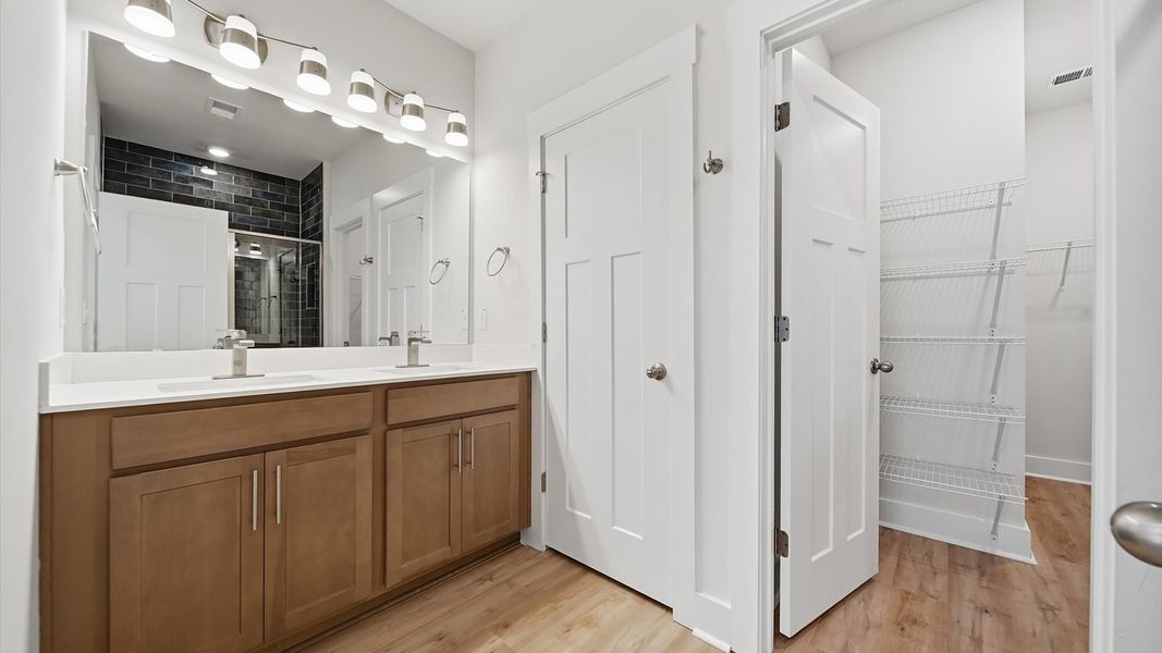 First-rate primary bathroom offering an elegant walk-in shower and dual sinks with superior style First-rate primary bathroom offering an elegant walk-in shower and dual sinks with superior style