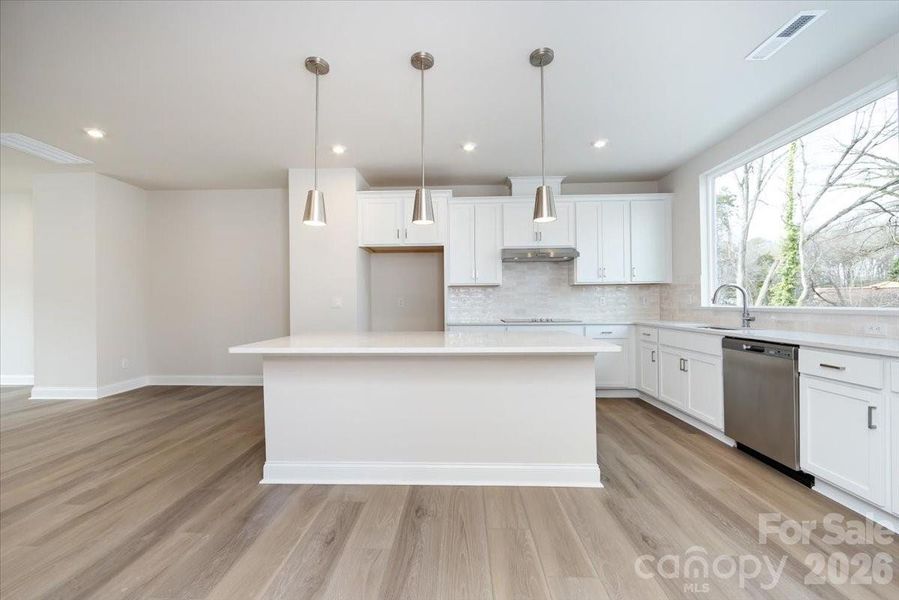 Gourmet Kitchen with Large Window for Abundant Natural Light Gourmet Kitchen with Large Window for Abundant Natural Light