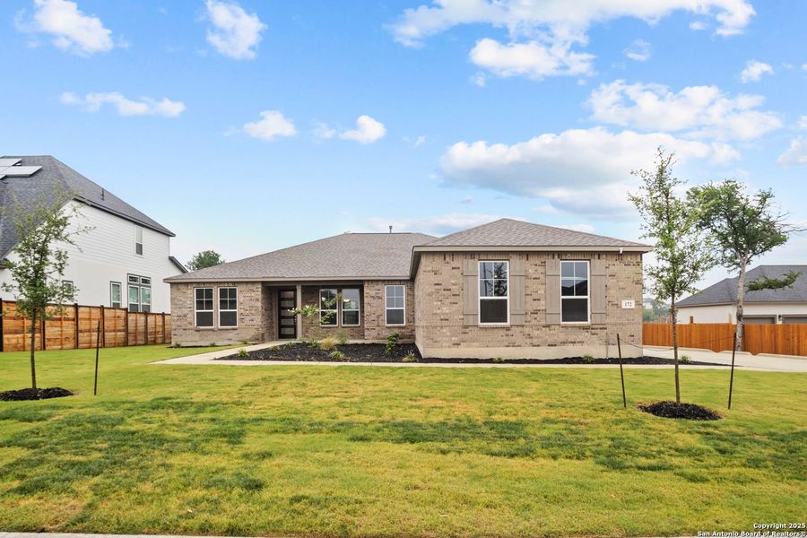 Front exterior of a new home in Potranco Oaks, Castroville, TX, highlighting curb appeal (Image 21).
