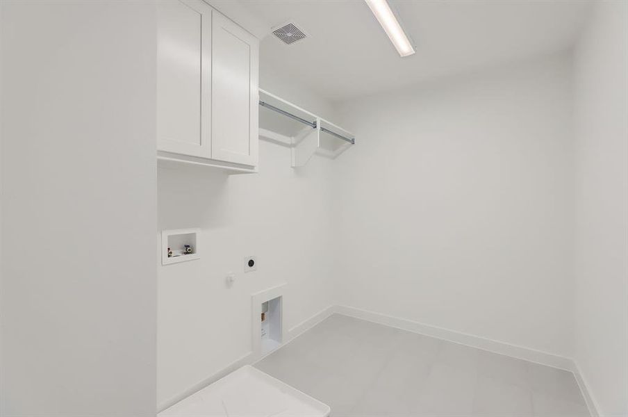 Laundry room featuring cabinets, electric dryer hookup, hookup for a gas dryer, and washer hookup