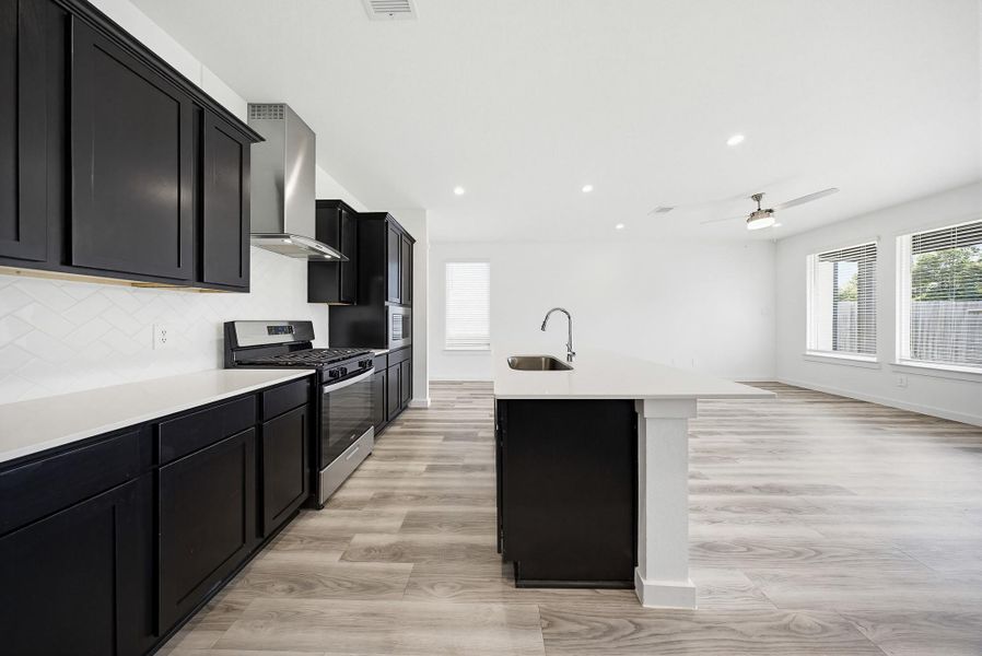 Kitchen equipped with stainless steel appliances, refrigerator included
