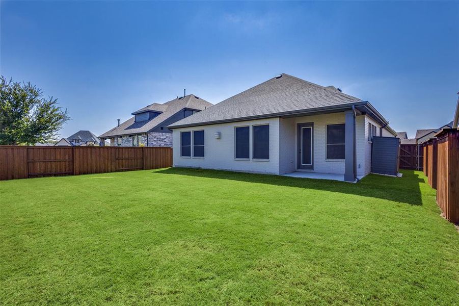 Rear Patio and large yard with luscious green grass Rear Patio and large yard with luscious green grass