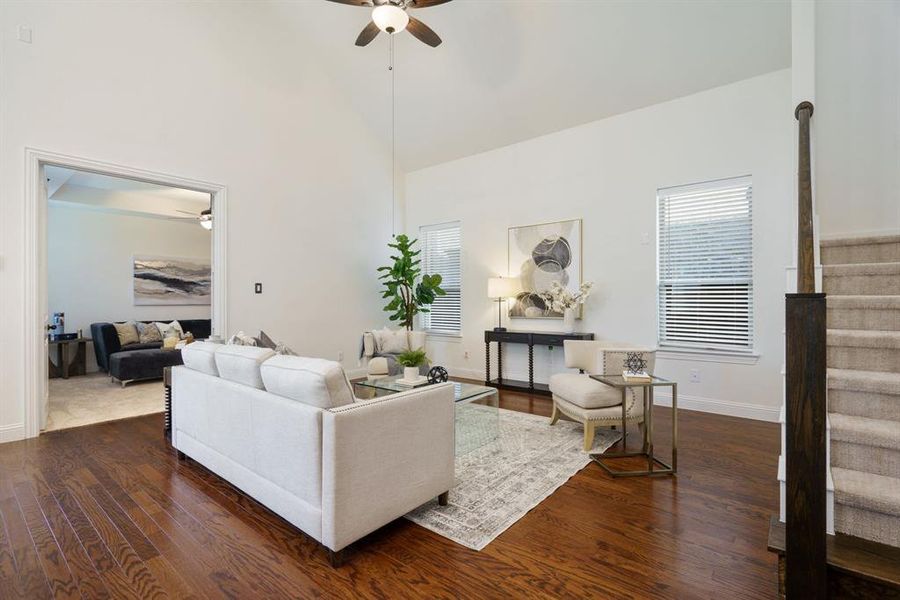 A warm, cozy living room with wood floors and enough space to host your favorite people in comfort.