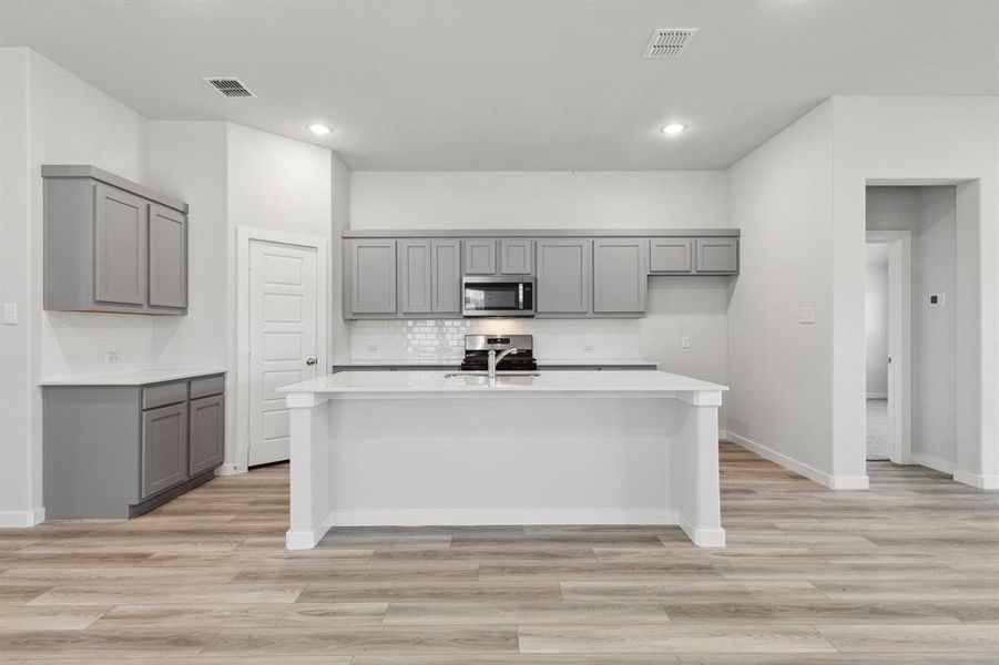 Kitchen in the Quartz home plan by Trophy Signature Homes – REPRESENTATIVE PHOTO