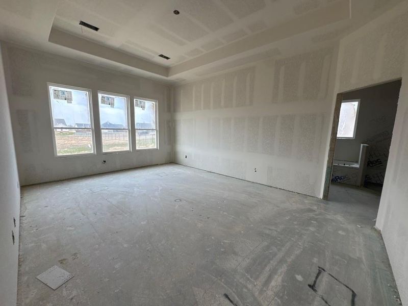 Empty room featuring a tray ceiling Empty room featuring a tray ceiling