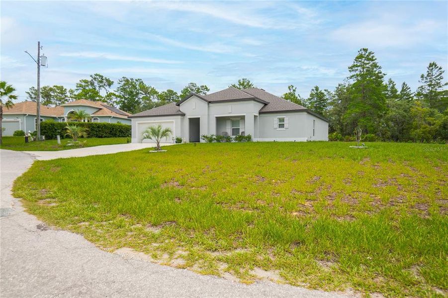 Front exterior of a new home in , Homosassa, FL, highlighting curb appeal (Image 1). Front exterior of a new home in , Homosassa, FL, highlighting curb appeal (Image 1).