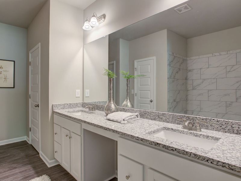 Elegent primary bathroom with dual vanities