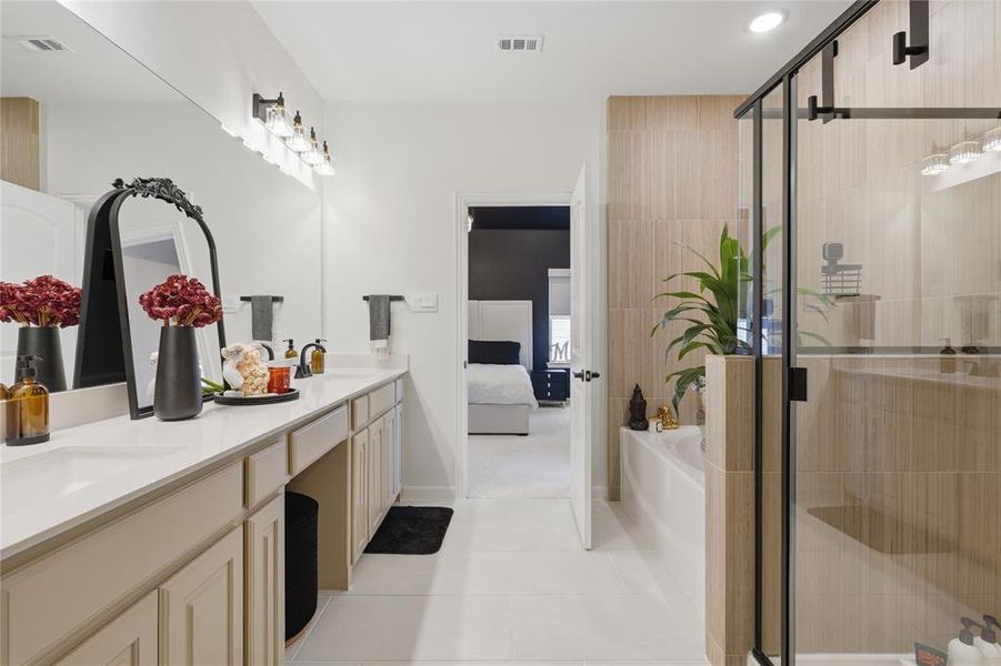 Spacious bathroom featuring a dual vanity with light-toned cabinetry and a white countertop Spacious bathroom featuring a dual vanity with light-toned cabinetry and a white countertop
