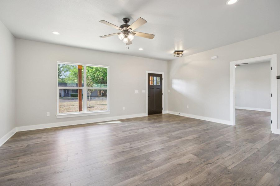 Unfurnished living room featuring recessed lighting, wood finished floors, and a ceiling fan