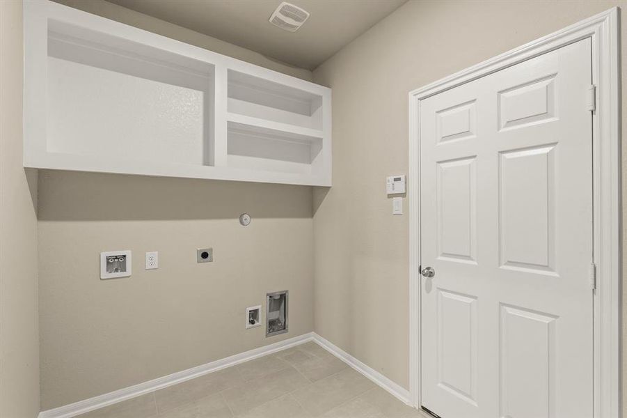 The laundry room layout is carefully planned for optimal workflow with designated areas for washing, drying, and storing.