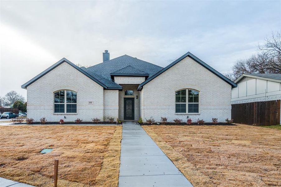 French provincial home with a front lawn