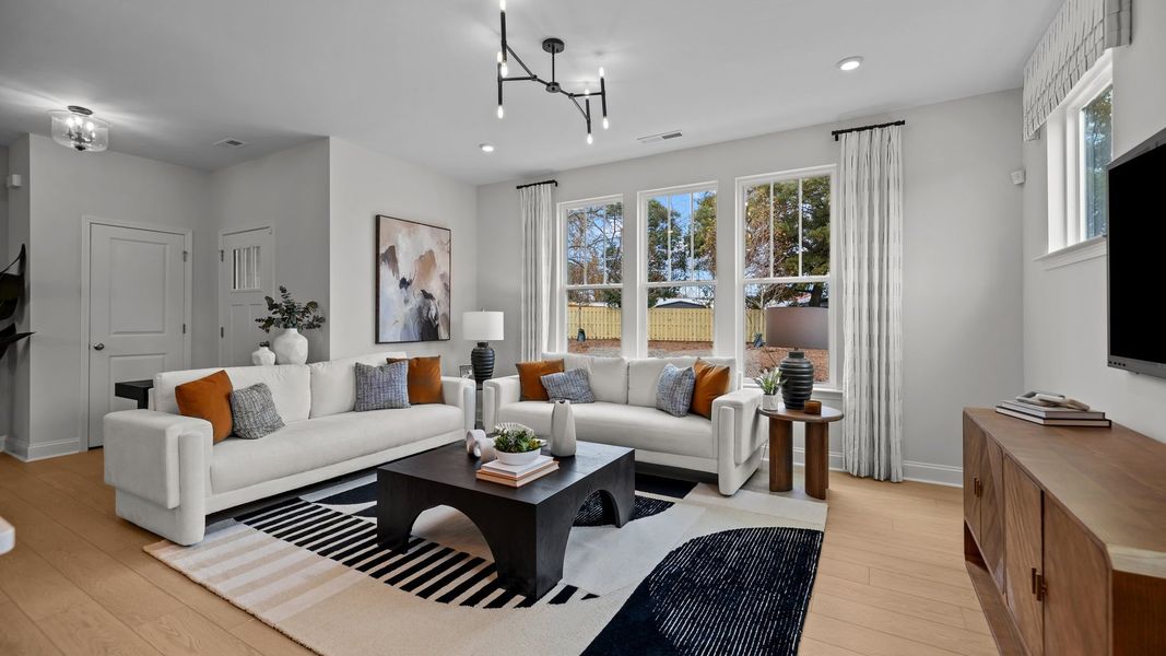 Family room with premium lighting, large windows, and elevated ceiling in the Adaline plan by DRB Homes Charlotte, NC