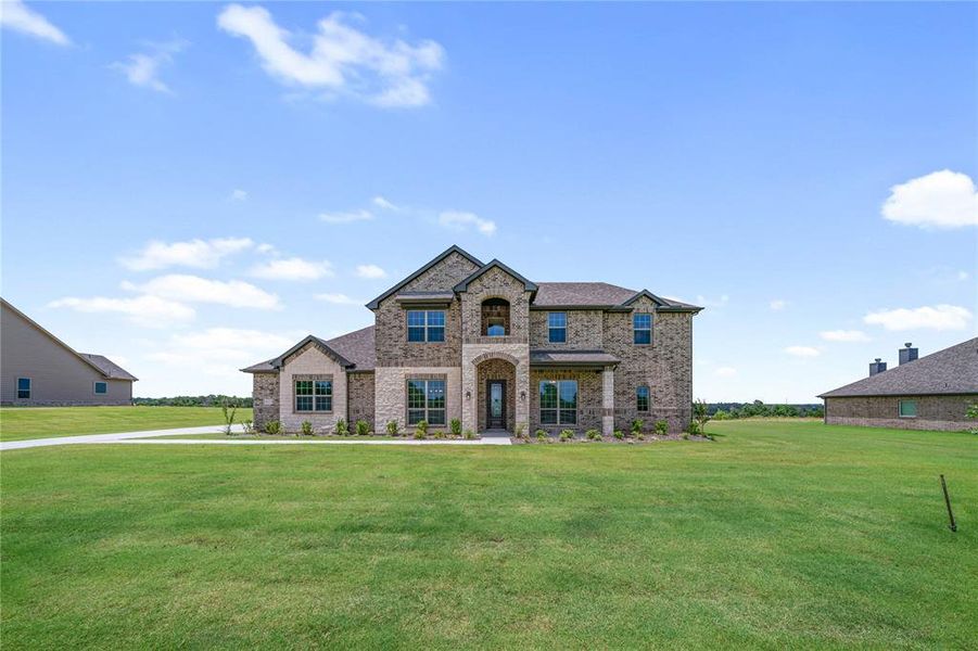 Front exterior of a new home in Eagle Ridge Estates, Weatherford, TX, highlighting curb appeal (Image 26). Front exterior of a new home in Eagle Ridge Estates, Weatherford, TX, highlighting curb appeal (Image 26).