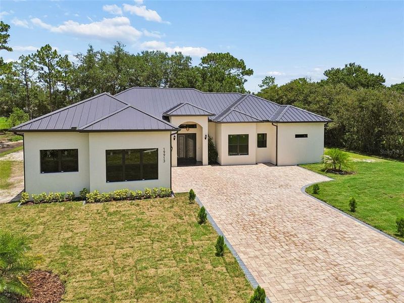 Front exterior of a new home in , Orlando, FL, highlighting curb appeal (Image 27). Front exterior of a new home in , Orlando, FL, highlighting curb appeal (Image 27).