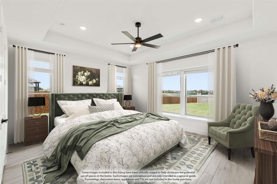 Master bedroom with tufted green headboard, ceiling fan, large windows, and light wood floors Master bedroom with tufted green headboard, ceiling fan, large windows, and light wood floors