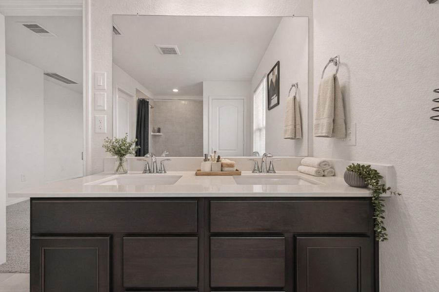 Bright double-vanity bath with oversized mirror, sleek fixtures, and clean modern finishes throughout.