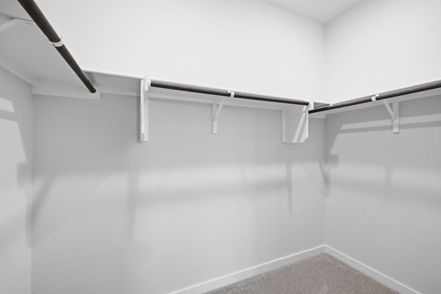 Functional closet system featuring ample shelving and hanging rods for organized storage.