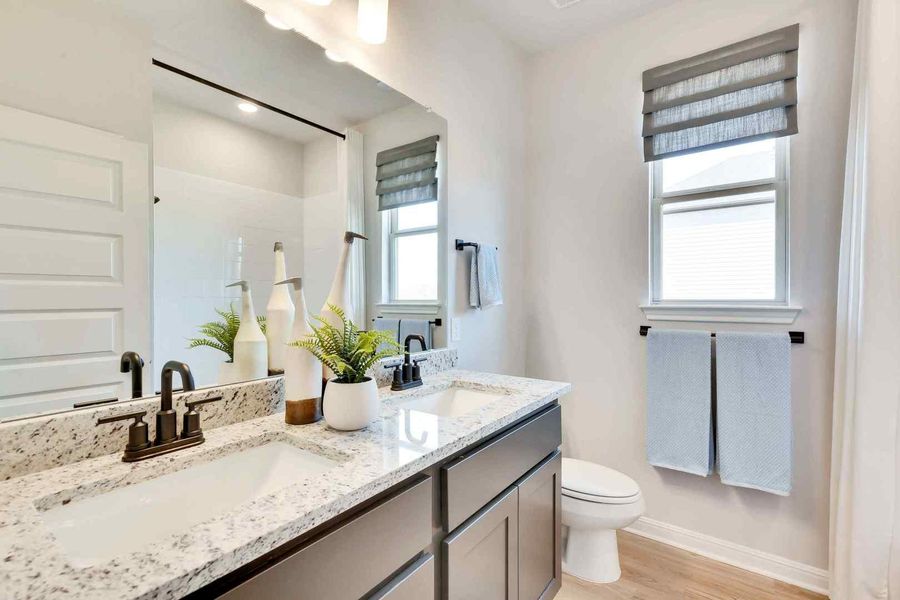 Double vanity with ample counter space and a modern toilet, ready for daily routines. Double vanity with ample counter space and a modern toilet, ready for daily routines.