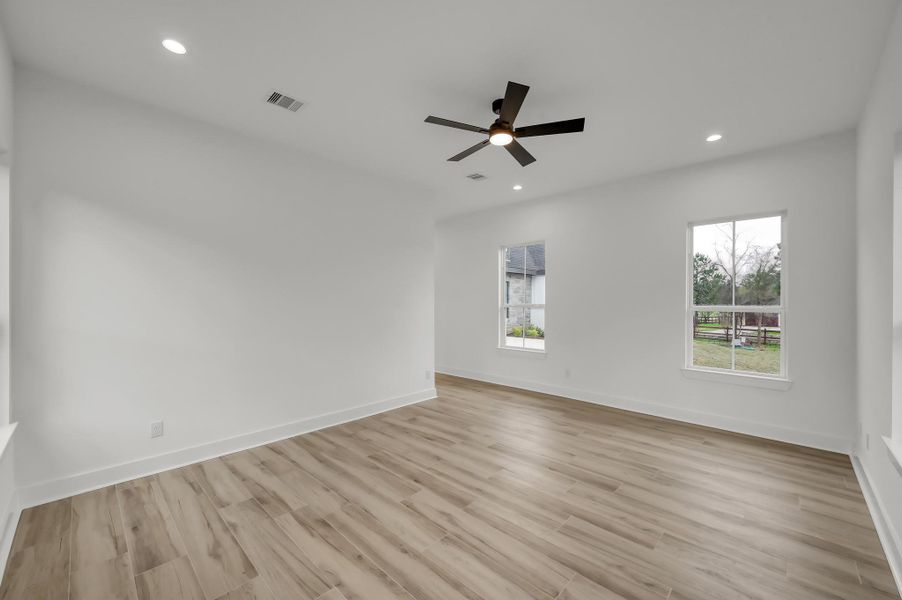Primary suite perspective showing the entry to the hallway and sliding barn-style doors leading toward the primary bath area.