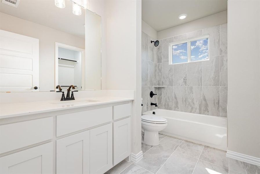 Bathroom featuring shower / washtub combination and vanity